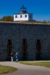 Walking By Clarks Point Light on Stone Wall of Fort Taber
